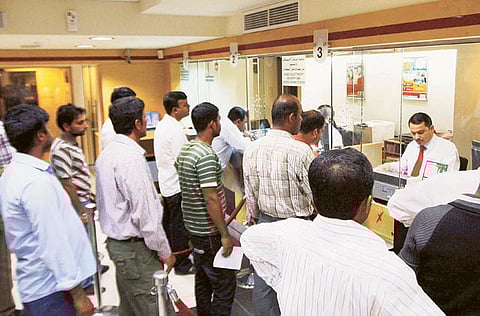 Customers at a currency exchange in Sharjah.