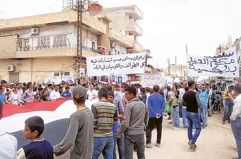 In this file picture, Syrian ethnic Kurds demonstrate after in Qamishli.