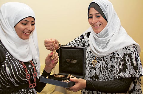 Radwa Hassan Al Taweel, who scored 99 per cent in Arts stream from AQS school in Abu Dhabi, receives