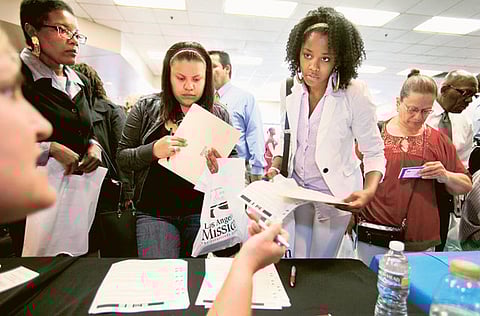Candidates register at a jobs fair.