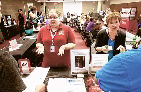 Jobseekers speak with recruiters at the Abraham Lincoln Presidential Library and Museum booth during a job fair at the
University of Illinois Springfield campus on Thursday. The US jobless rate held at 9.1 per cent in August.