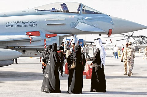 File picture shows people stand next to a Royal Saudi Air Force F16 jet during the opening ceremony of the Bahrain Airshow in Sakir Base,south of Manama.