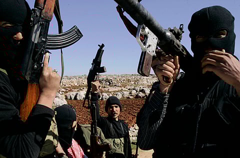 Syrian rebels man a checkpoint in the north of northern Syria's Idlib region.