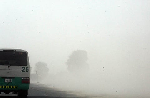 A sand storm reduces visibility on Emirates Road.