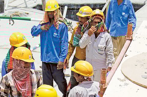 Workers take a break at a construction site in Dubai.