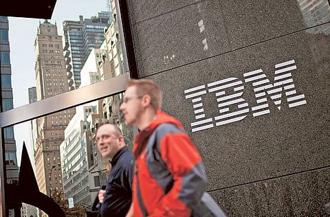 Pedestrians walk past International Business Machines Corp. (IBM) offices in New York.