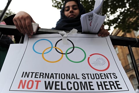 A woman demonstrates outside 10 Downing Street in London, against the government's decision to strip London Metropolitan University of its right to sponsor visas for foreign students. File photo.