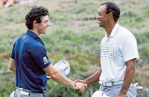 Rory McIlroy shakes hands with Tiger Woods in 2012. Their friendship and rivalry goes way back.