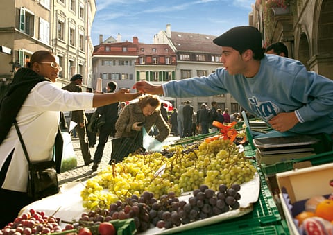 Tourists at a market in Lausanne Switzerland.Europe's airlines and travel sector are bracing for a second lost summer, with rebound hopes increasingly challenged by a hobbled COVID-19 vaccine rollout.