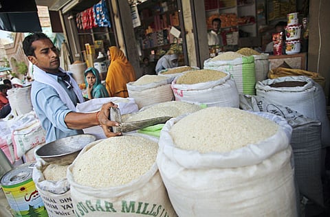 A vendor scoops a measure of rice from a bag at a market in the district of Faisalabad in Punjab, Pakistan. Pakistan’s economic growth is projected to shrink to 2.6 per cent in 2020 from 3.3 per cent in 2019 according to Asian Development Bank.