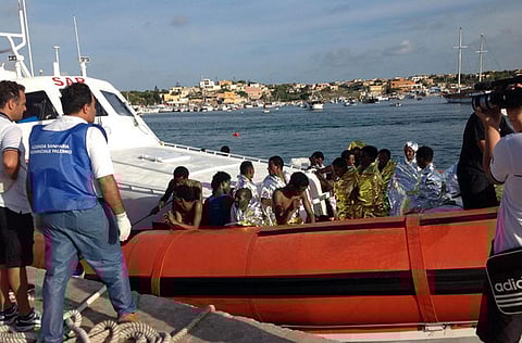 An Italian Coast Guard boat carry rescued migrants as they arrive in the port of Lampedusa.
