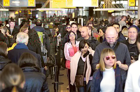 Travellers wait to pass through customs at JFK Airportin New York. Groups representing the US travel industry and airlines on Friday voiced opposition to mandatory quarantines for air passengers arriving in the United States.
