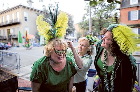 File photo: Bev Kehayes, left, of Greensboro, N.C., gets her homemade hat pinned on her head by her friend Mary Parrish, center, and Sara Farnsworth, right, before Savannahs 189-year-old St. Patricks Day parade, Saturday, March 16, 2013, in Savannah, Ga. St. Patrick's Day falls on March 17, which is Sunday. But a number of cities, including Savannah, New York and Chicago are all holding parades Saturday to take advantage of the full weekend.