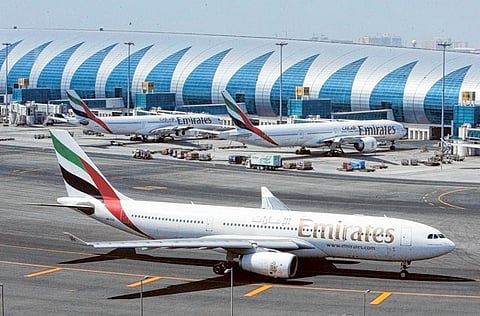 An Emirates Airlines plane taxis on the tarmac at the Dubai International.