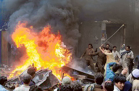 Angry Pakistani demonstrators torch a Christian’s belongings during a protest over a blasphemy row in a Christian neighborhood in Badami Bagh area of Lahore on March 9, 2013.