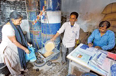 A woman who holds a BPL (Below Poverty Line) card buys wheat from a government-run shop in the western Indian city of Ahmedabad.