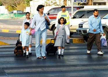 School zones are required to have special pick-up and drop-off zones for both parents and school buses and clear signs warning motorists they are entering special zones. For illustrative purposes only.
