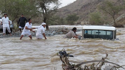 File picture: Rescue efforts underway to save a driver caught in floods in Saudi Arabia.