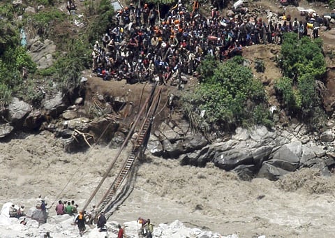 File image used for illustrative purposes: Indo-Tibetan Border Police (ITBP) personnel, in uniform, helping stranded pilgrims on a makeshift bridge cross a stream of gushing floodwater at Govind Ghati, in Chamoli district, in northern Indian state of Uttarakhand.