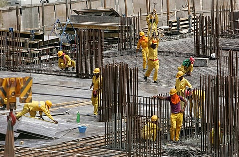 Labourers work at a construction site in Dubai.