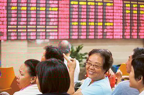 Investors in Shanghai, China. The spectre of state intervention into controlling the private sector has created a crescendo of panic-selling.