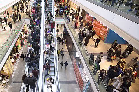 Customers are seen traveling on escalators as they shop for discounted goods at the Westfield Stratford City mall in London, U.K.