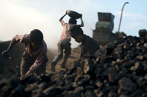 File photo: Indian children carry coal in baskets at a road side coal depot in the East Jaintia Hills district of the Indian northeastern state of Meghalaya.