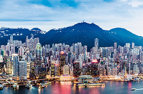 View of Victoria Harbour and Skyline in Hong Kong. Faced with a tax rate as high as 45% - up from about 15% previously - Chinese professionals across Hong Kong are considering moving back home to avoid getting squeezed by both the new levy and sky-high living costs.
