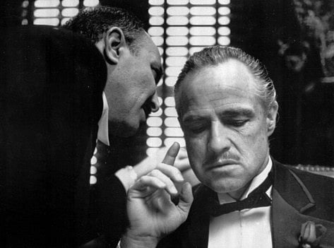Marlon Brando, right, as Don Corleone, in a scene from the 1972 movie, "The Godfather". A storied $125 million mansion in Beverly Hills that was featured in the movie is now bankruptcy protection.