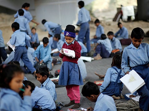 A schoolgirl at an open-air school in New Delhi. In June, thousands of schools in Gujarat were given textbooks by Batra that claimed cars were invented in ancient India.