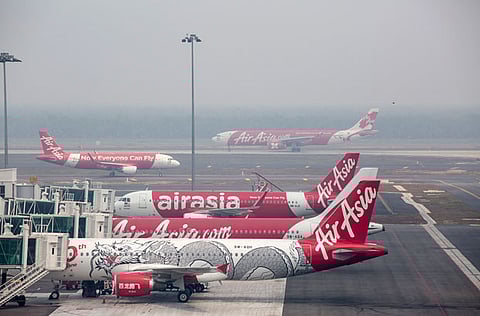 An AirAsia X Bhd aircraft taxi on the runway. AirAsia X Bhd. will seek to restructure about 63.5 billion ringgit ($15.3 billion) of debt and reduce 90% of the company’s capital, according to a stock exchange filing.