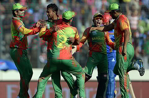 Afghanistan batsman Najeeb Tarakai (partially hidden) is dismissed as Bangladesh players celebrate during their match in T20 World Cup 2014 in Dhaka.