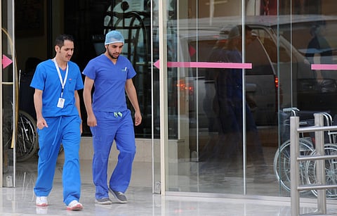 Saudi medical staff leave the emergency department at a hospital in Riyadh.