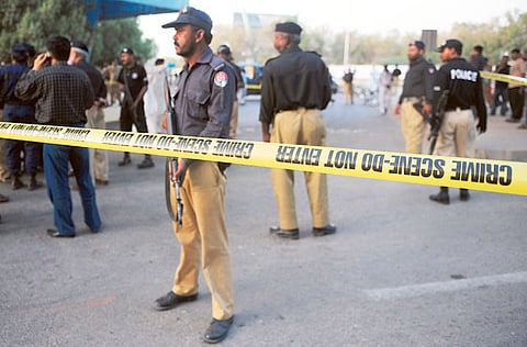 Pakistani security personnel working at the scene after an attack on a Pakistani journalist in Karachi.