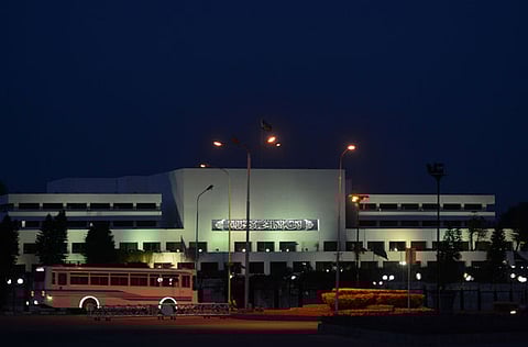 A bus passes the Pakistan parliament building in Islamabad.