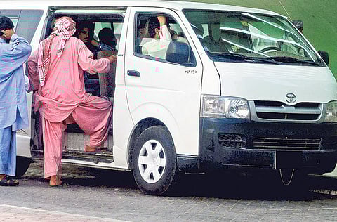 File: Passengers boarding a 14-seater minibus in Abu Dhabi. For illustrative purposes only