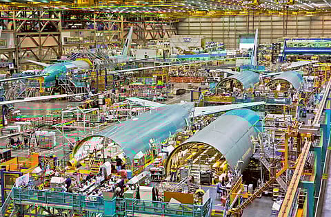 An overhead view workers on the final assembly line of a Boeing 777 airplane at the Boeing Everett Factory in Everett, Washington. US plane-maker Boeing has called 2020 “unprecedented” in terms of disruption to the aviation industry and lowered its forecast for commercial airplane demand.