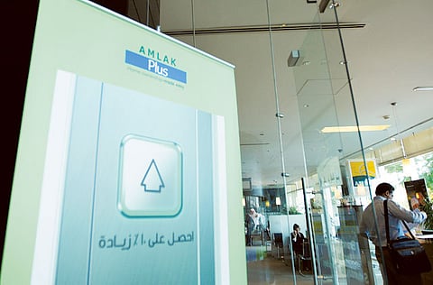 Customers in a branch of mortgage firm Amlak Finance. Amlak reported a net profit of Dh6 million for Q1 2021, compared to Dh139 million net loss in Q1 2020.