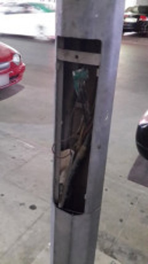 Open wires on lamppost pose threat to community