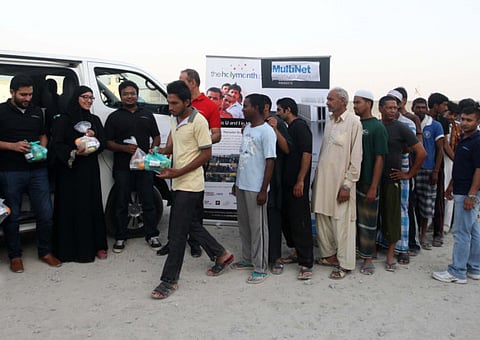 Terrific trio distribute 6,500 snack-packs among workers