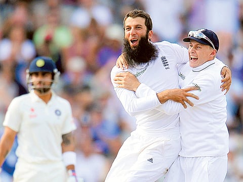 England’s Moeen Ali (centre) jubilates with teammate Joe Root after dismissing India’s Cheteshwar Pujara (not pictured) during a Test match at Old Trafford during their 2014 series.
