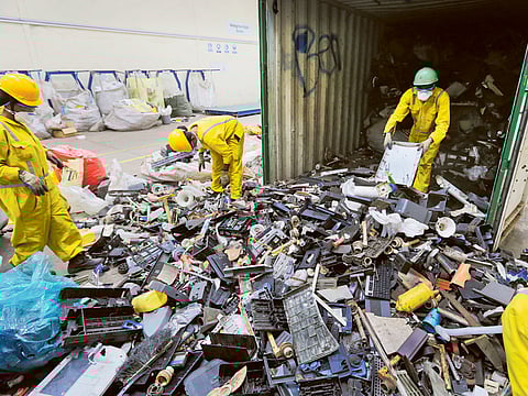 Workers sort through electronic waste. The amount of e-waste generated globally last year represents more than 6.8 kilograms for every living person, according to the UN.