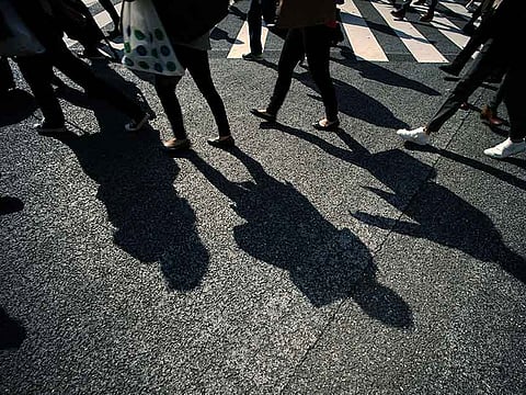 Shadows of pedestrians on a busy scramble crossing. Picture for illustrative purposes only.