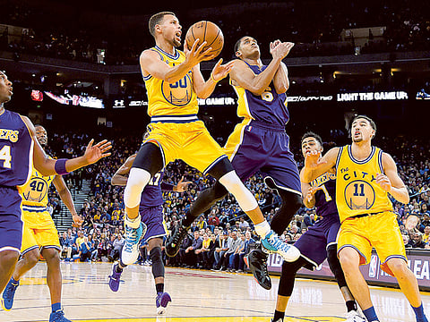 Stephen Curry of the Golden State Warriors shoots over Jordan Clarkson of the Los Angeles Lakers during their NBA game at the Oracle Arena in Oakland, California.