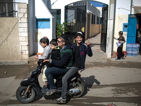 A boy gestures to the camera on the island of Djerba, southeastern Tunisia