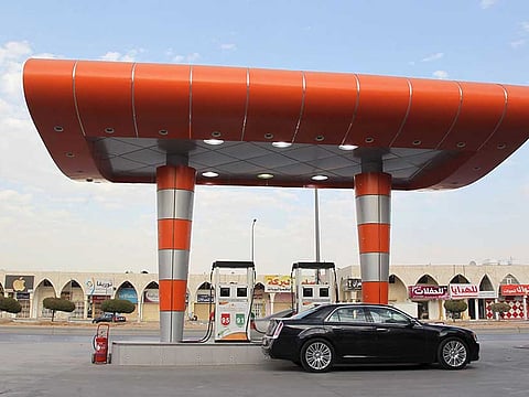 A driver waits to fill his car with fuel at a petrol station in Riyadh, Saudi Arabia.