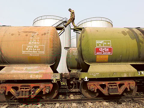 File photo: A worker check freight levels at an oil terminal on the outskirts of Kolkata.