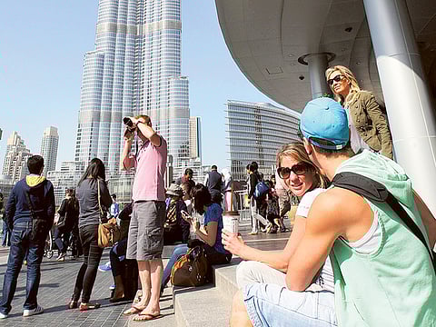 Tourists near the BurjKhalifa in DowntownDubai. Last festive season from December 8 to January witnessed a big jump in UAE’s card spend, largely driven by international visitors to key Dubai tourist attractions according to data from Network International.