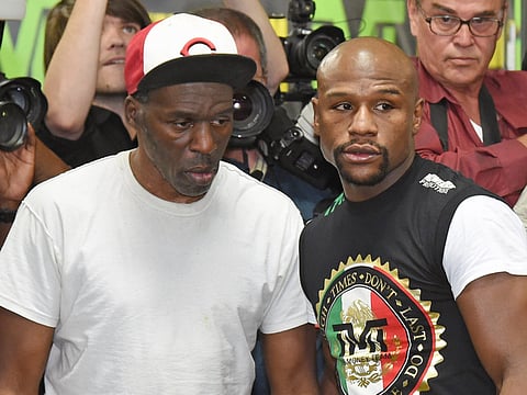 Roger Mayweather (left), alongside nephew Floyd, for whom he had also served as a trainer.
