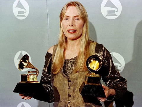 Joni Mitchell holding two Grammy Awards for Best Pop Album, "Turbulent Indigo," during the 38th Annual Grammy Awards in Los Angeles on February 28, 1996.